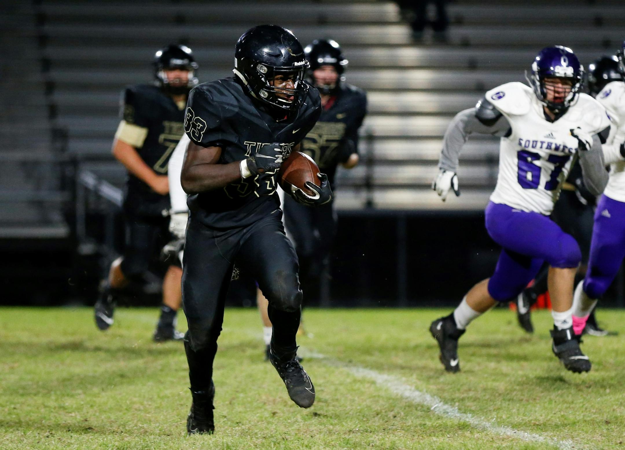 Fridley's Michael Ude (33) sprints to the outside on a sweep against Minneapolis Southwest. Ude had one rushing TD in the Tigers’ 34-7 victory over the Lakers in Fridley. Photo by Jeff Lawler, SportsEngine