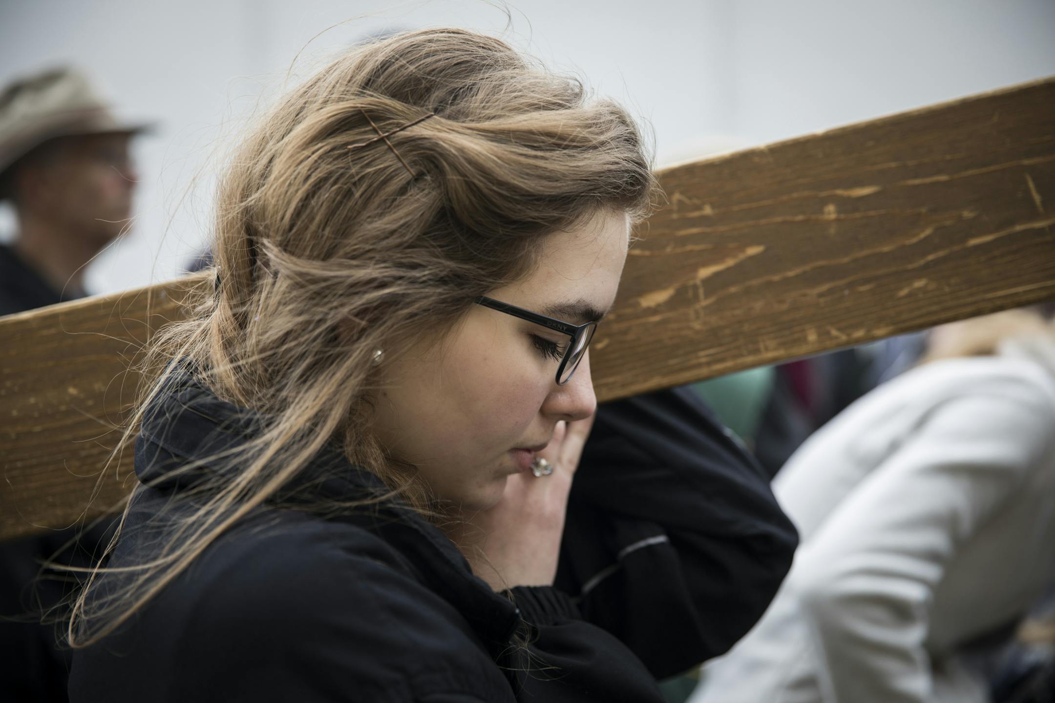 Katie Dufner prayed as she helped carry a cross outside Planned Parenthood during a pro-life protest on Good Friday in St. Paul, Minn., on April 14, 2017. ] RENEE JONES SCHNEIDER • renee.jones@startribune.com