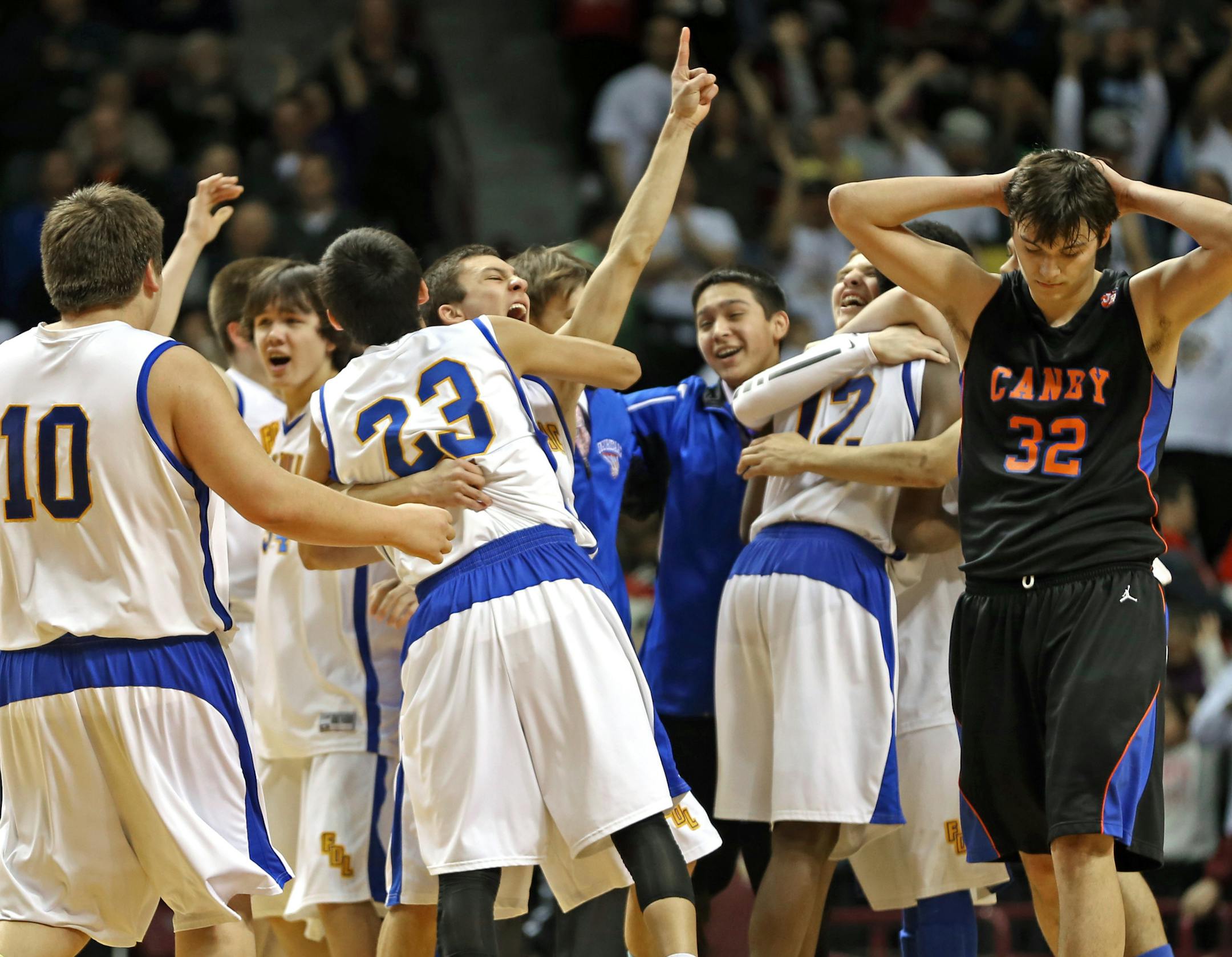 (left to right) Fond du Lac Ojibwe team members celebrated their overtime win as Canby walked off the court.] Boys Basketball Tournament, Fond du Lac Ojibwe vs. Canby, Class 1A game at Williams Arena, 3/13/14. Bruce Bisping/Star Tribune bbisping@startribune.com