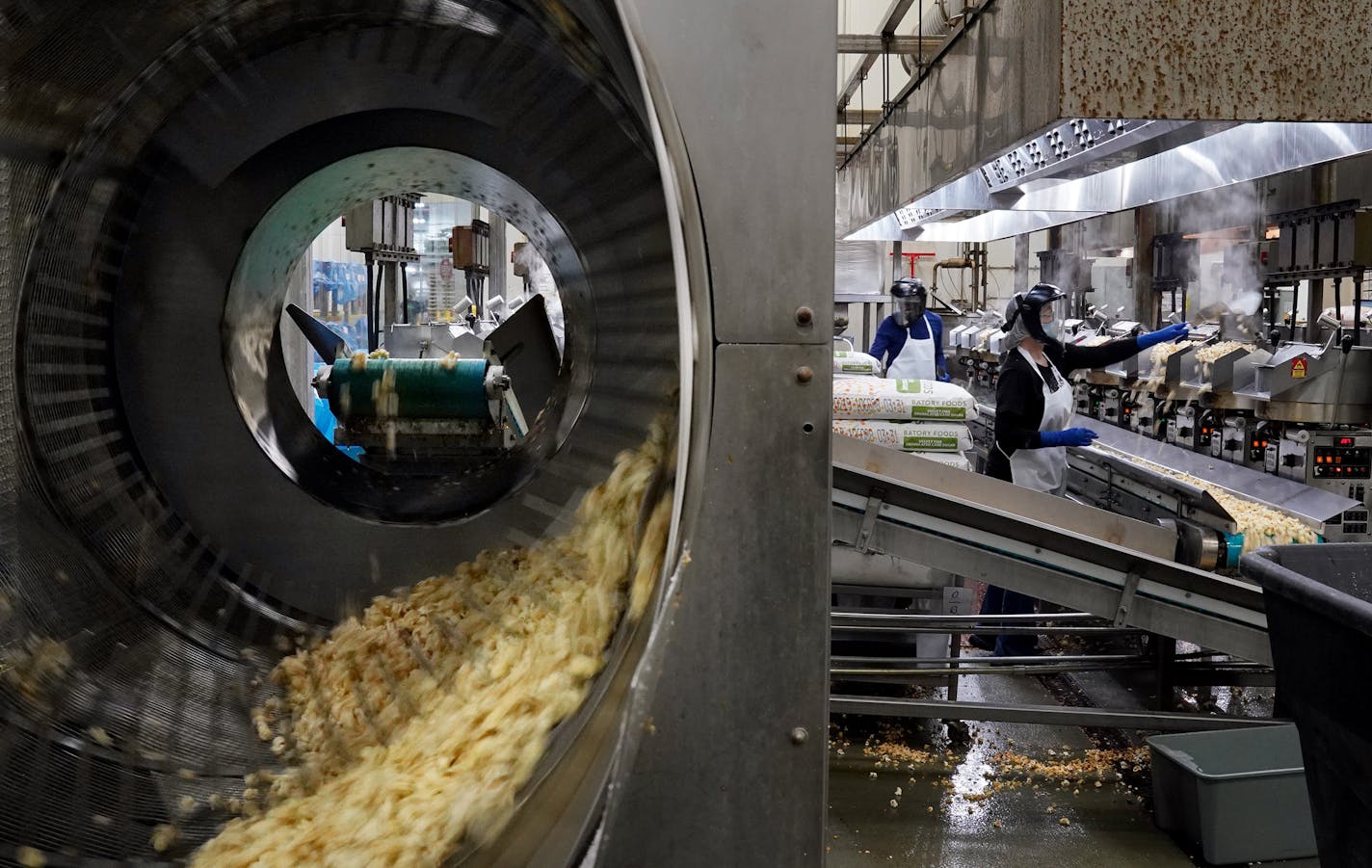 Popcorn moved via conveyor to a sifter at Kenny's Candy & Confections in Perham, Minn. Umbrella company KLN Family Brands and a related firm employ more than 1,100 people.