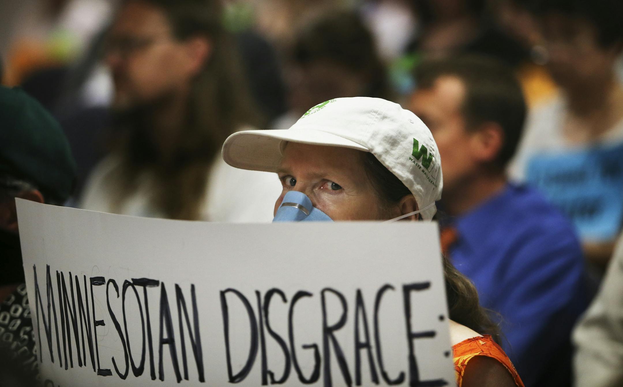 Connie Bonniwell of Robbinsdale, who suffers from multiple chemical sensitivity, held a sign that called using Canadian tar sand crude oil a "Minnesotan Disgrace" during the Public Utilities Commision meeting Wednesday, July 17, 2013, in St. Paul, MN.](DAVID JOLES/STARTRIBUNE) djoles@startribune.com Enbridge Energy seeks approval from MN regulators to expand a pipeline that would carry Canadian tar sands crude oil through the state and the Public Utilities Commision to vote on the possible pipel