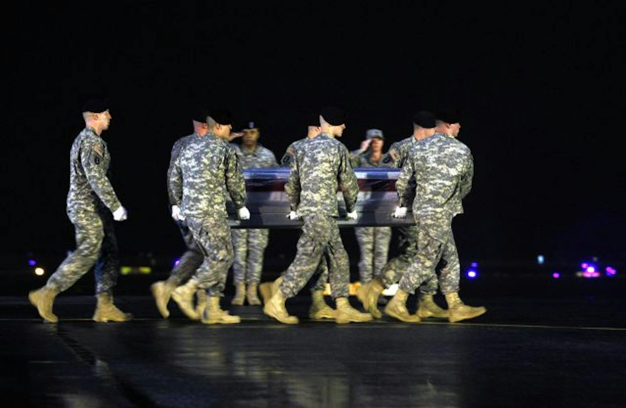 Soldiers carried the remains of Army Spc. Andrew Wilfahrt after it arrived at Dover Air Force Base on Monday. The family of Wilfahrt, who was from Rosemount, was in Dover to meet the plane carrying the military policeman's body. He died in Afghanistan Sunday when insurgents detonated a bomb.