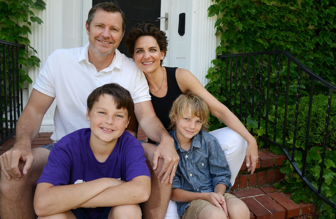 From top to bottom, left, Ted Jirele, Cynthia Froid, their children Eddie Jirele, 11, and Wally Jirele, 9, sit in front of their house in Minneapolis, Minn., on Sunday June 7, 2015. Ted and Cynthia's other son, Sam Jirele, 19, is not pictured. Realtor Cynthia Froid has carved out a niche as Mill District condo matchmaker. ] RACHEL WOOLF rachel.woolf@startribune.com