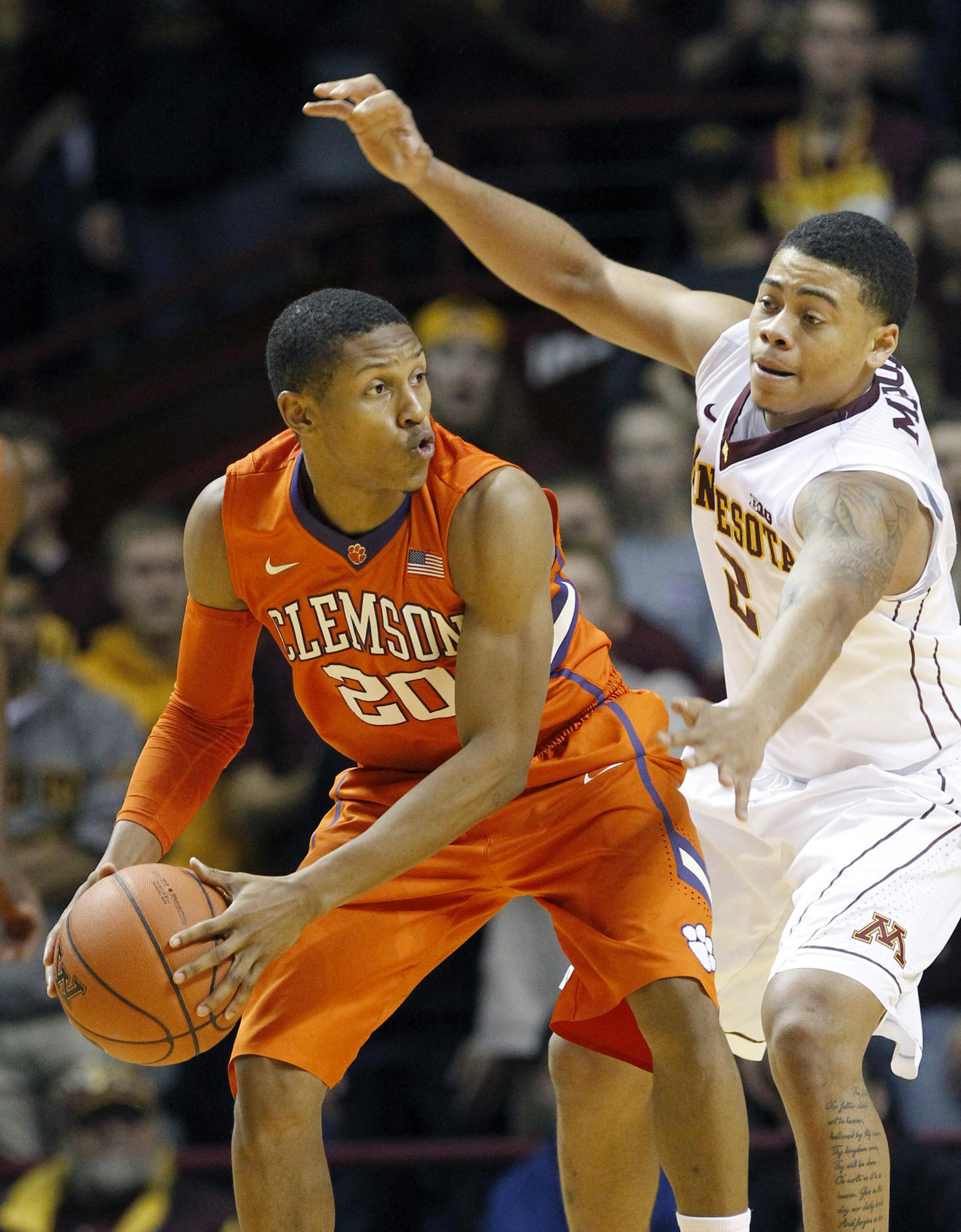 Clemson guard Jordan Roper (20) looks to pass to a teammate under pressure from Minnesota guard Nate Mason (2) during the second half of an NCAA college basketball game in Minneapolis, Monday, Nov. 30, 2015. Minnesota won 89-83. (AP Photo/Ann Heisenfelt)