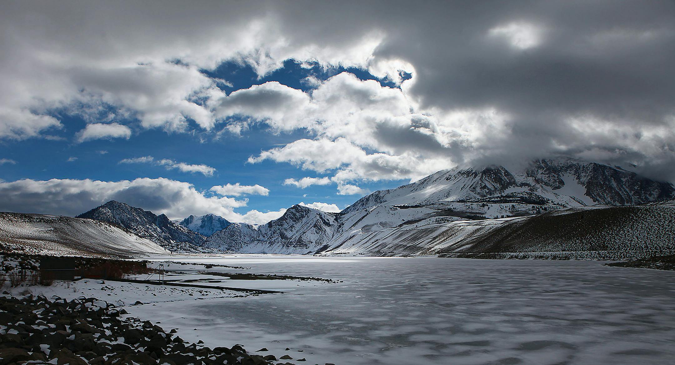 Clouds drift over a frozen Grant Lake Reservoir in a view from the lake's dam, January 29, 2013, in the Sierra Nevada. There is a proposal to make structural changes at the Grant Lake Spillway to facilitate greater water outflows into Rush Creek. (Brian van der Brug/Los Angeles Times/MCT) ORG XMIT: 1134612 ORG XMIT: MIN1302092256310339