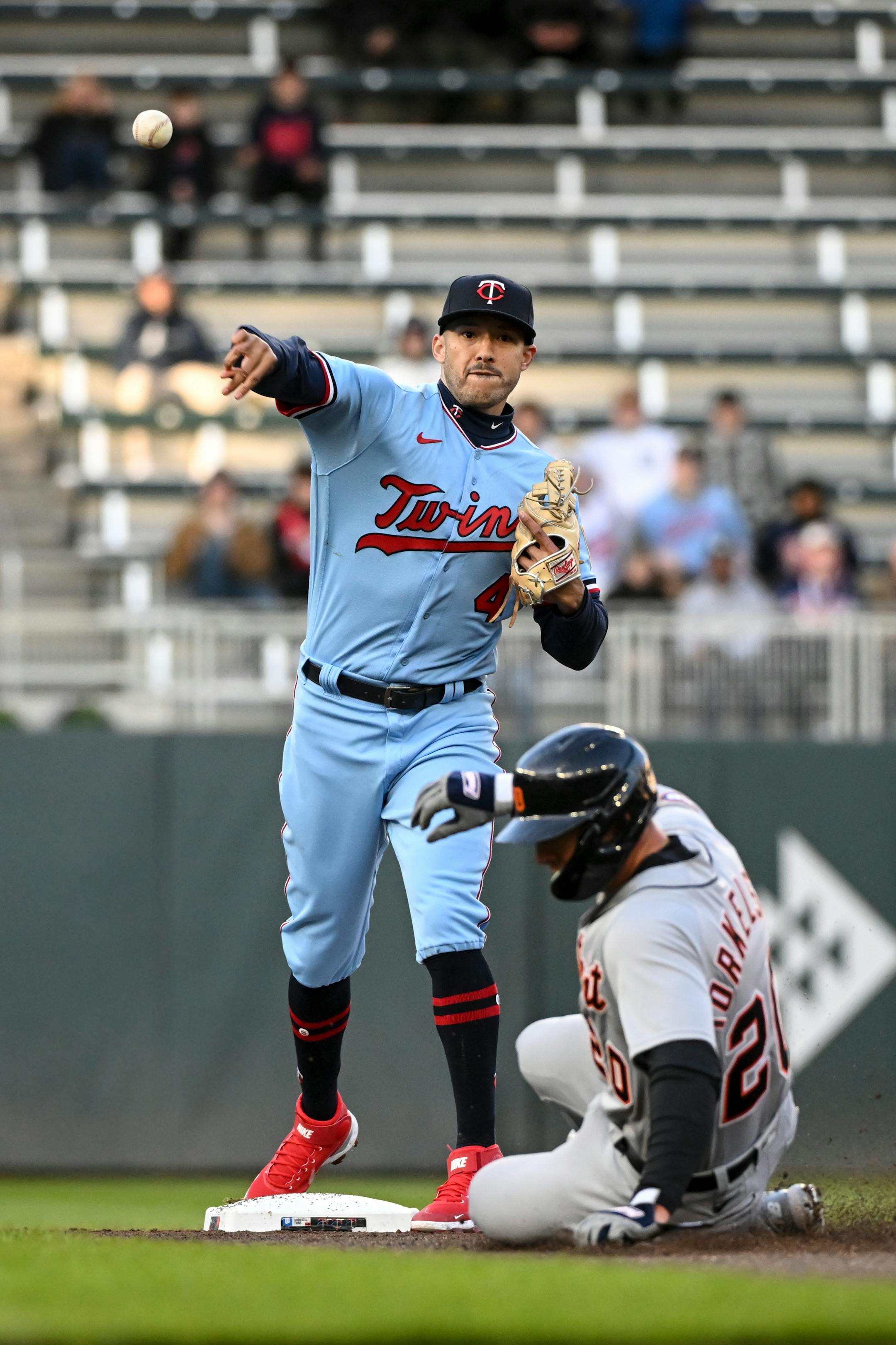 Detroit Tigers first baseman Spencer Torkelson (20) is out at second as Minnesota Twins shortstop Carlos Correa (4) turns a double play to first off a hit by third baseman Jeimer Candelario (46) in the top of the second inning.