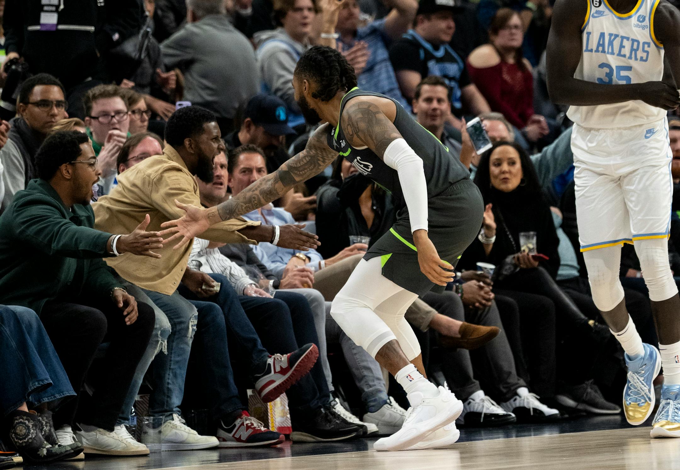 Minnesota Timberwolves guard D'Angelo Russell (0) high fives the fans after scoring in the second quarter.