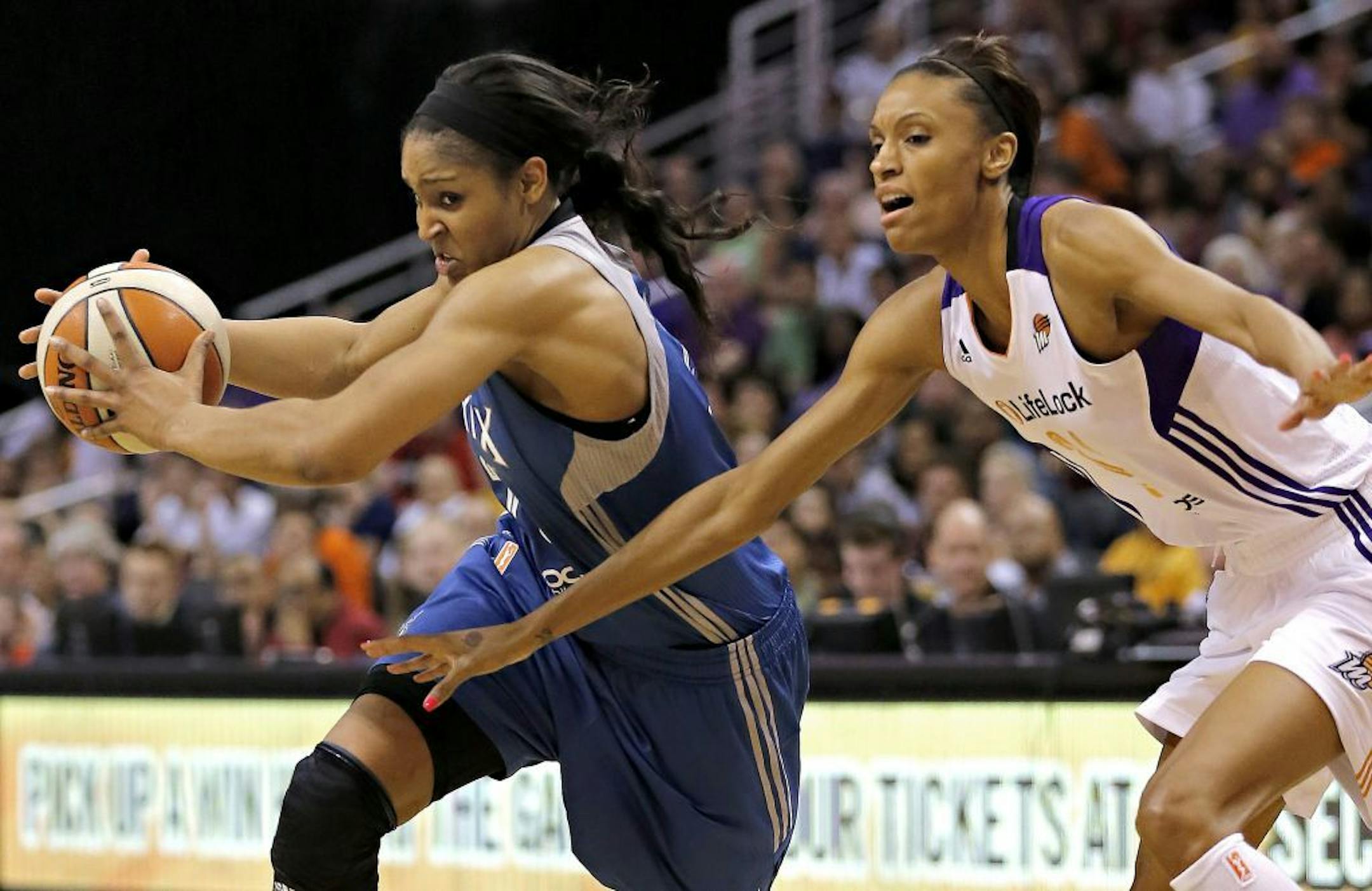 Lynx guard Maya Moore, left, drives past Phoenix Mercury forward Dewanna Bonner during the first half of a WNBA basketball game on Wednesday, June 19, 2013, in Phoenix.