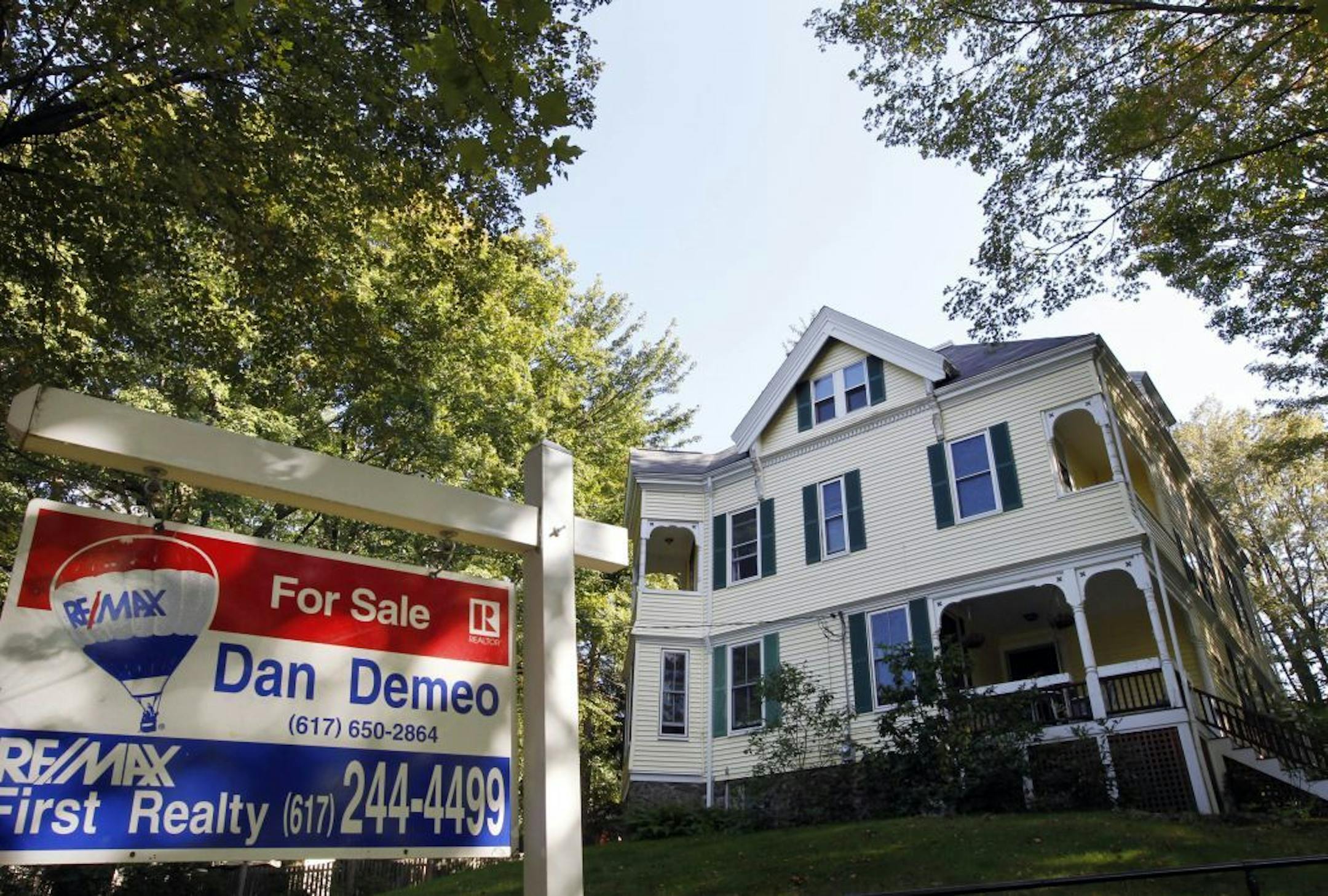 This photo taken Sept. 19, 2011, shows a home with a for sale sign in front, in Newton, Mass. The average rate on the 30-year fixed mortgage fell to 3.94 percent this week, the lowest rate ever. For those who can qualify, it's an extraordinary opportunity to buy or refinance.
