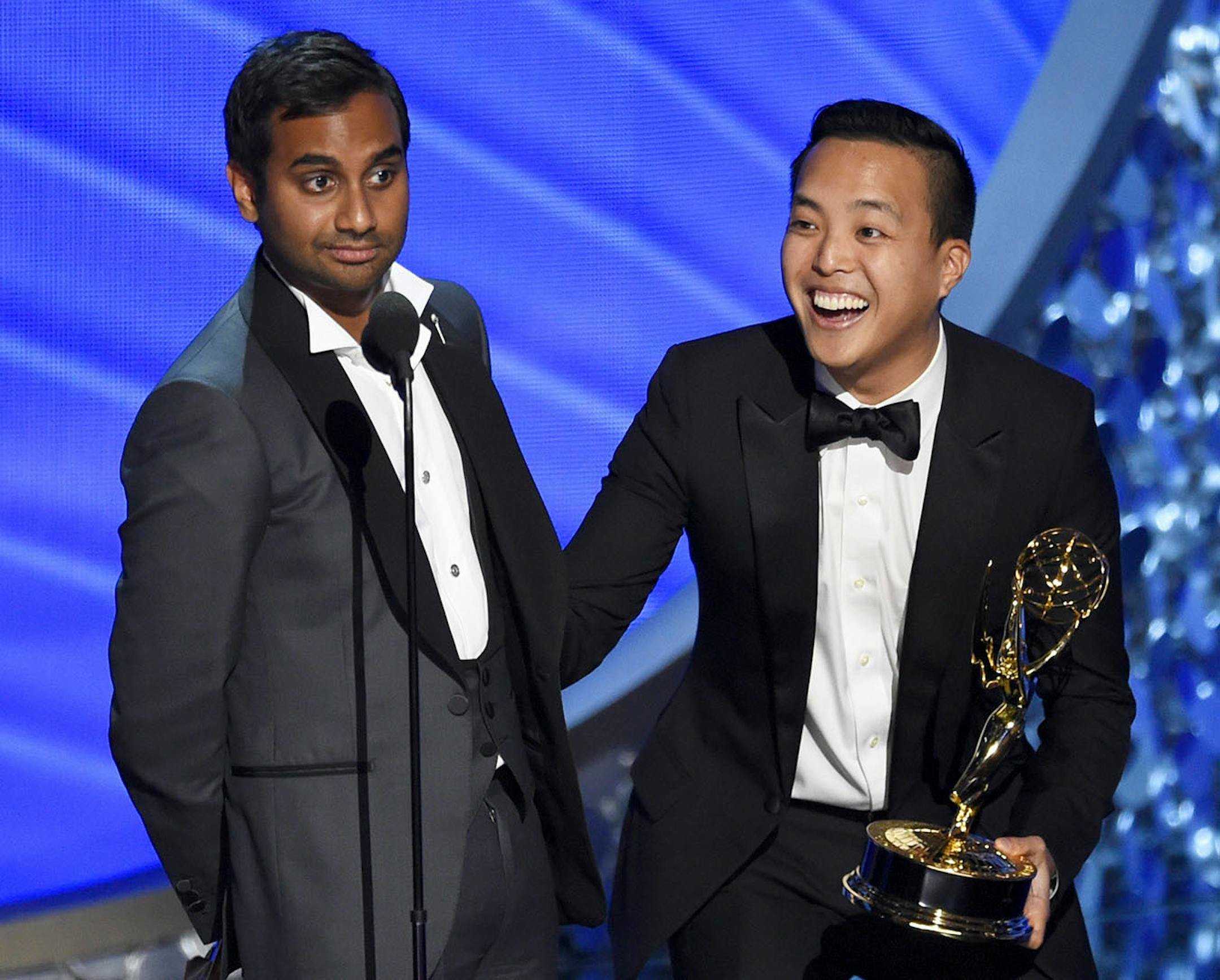 Aziz Ansari, left, and Kelvin Yu accept the award for outstanding writing for a comedy series for ìMaster of Noneî at the 68th Primetime Emmy Awards on Sunday, Sept. 18, 2016, at the Microsoft Theater in Los Angeles. (Photo by Chris Pizzello/Invision/AP)