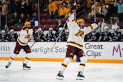 University of Minnesota players celebrate their third goal against Penn State during the third period.
