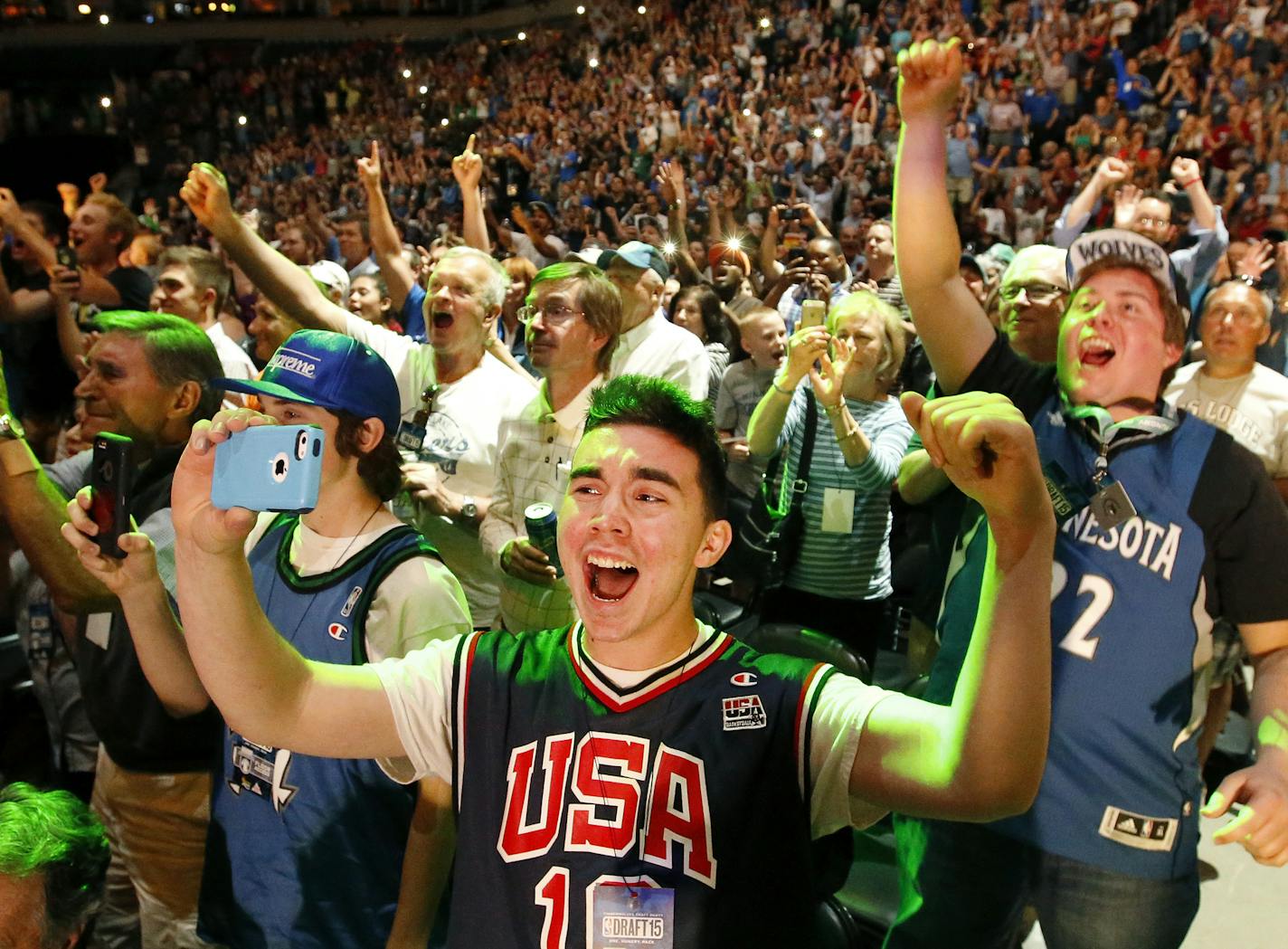 Minnesota Timberwolves fans Jordan Hennessey, 16, Jack Hennessey (middle) and Jeff Johnson (right) cheered after the Timberwolves selected Karl-Anthony Towns with the first pick of the 2015 NBA draft. ] CARLOS GONZALEZ cgonzalez@startribune.com - June 25, 2015, Minneapolis, MN, Target Center, NBA Draft, Minnesota Timberwolves have the number one overall pick