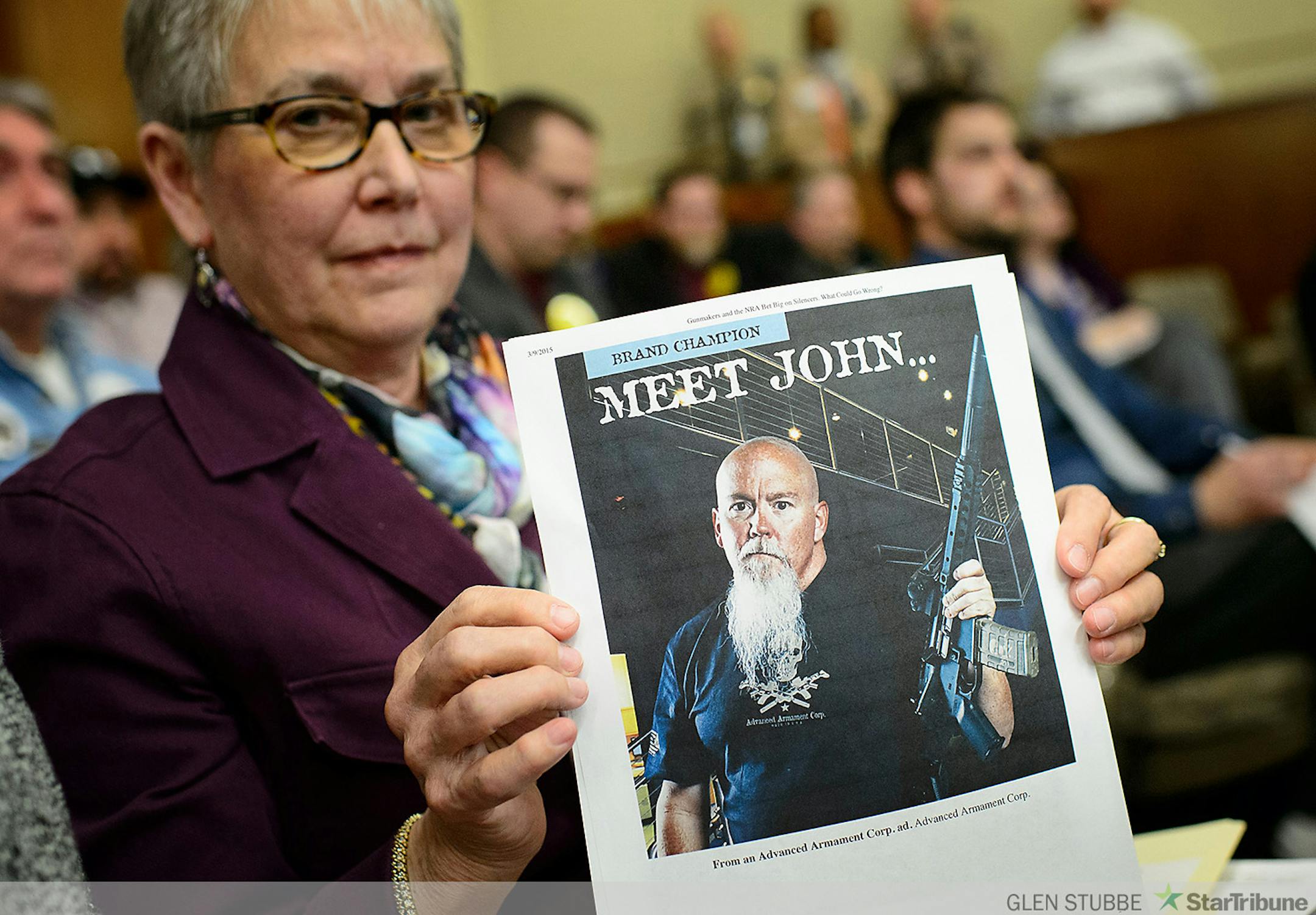 Joan Peterson challenged the notion that the main reason to allow suppressors was to protect shooters hearing by holding up advertisements from suppressor manufacturers that will increase profits if Minnesota lifts the prohibition on their use and posession.   ] GLEN STUBBE * gstubbe@startribune.com  Thursday, March 12, 2015