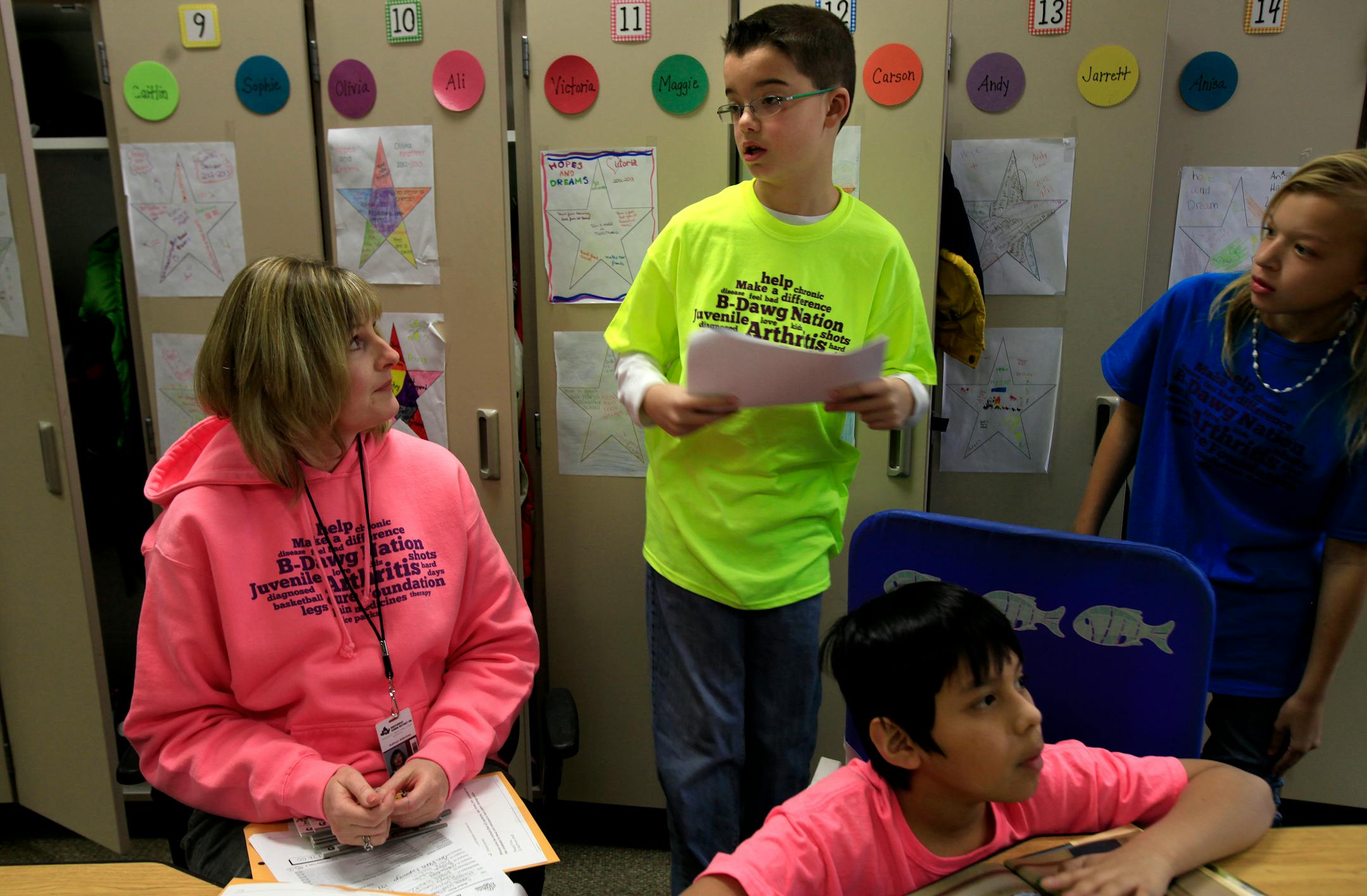 Jarrett Michie, 10, 5th grade student at Diamond Path School talks to his teacher Kathy Alderman about his homework in Apple Valley, MN on January 23, 2013.