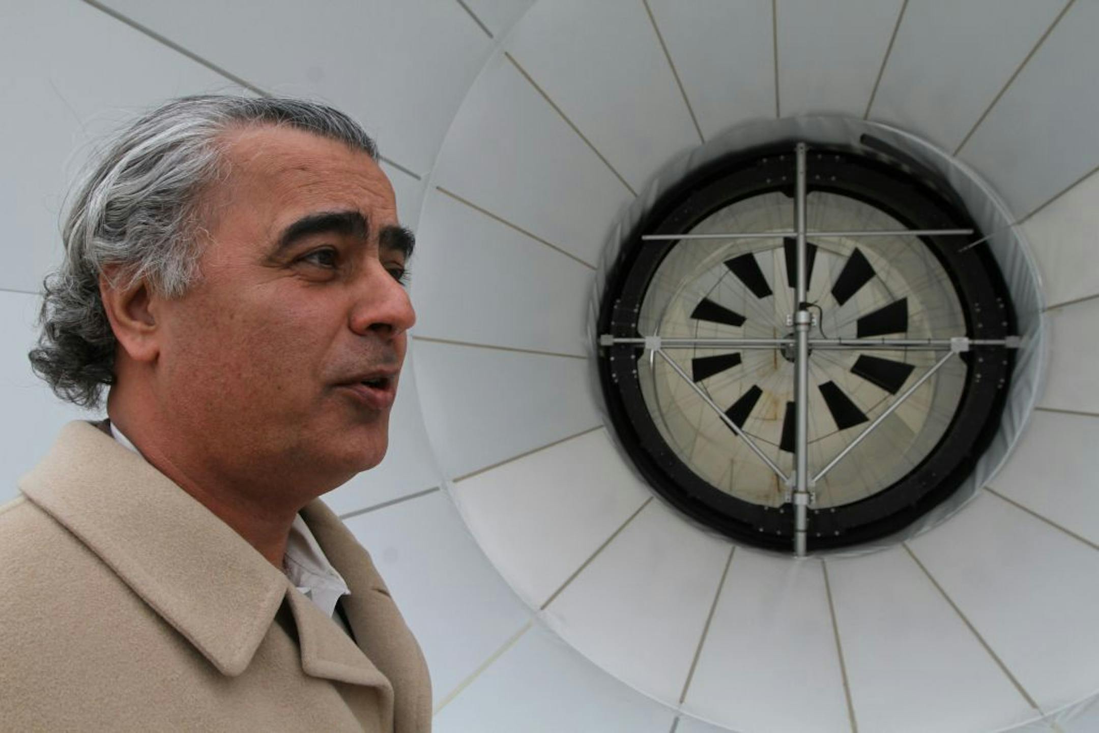(left to right) Dr. Daryoush Allaei, CEO of Sheerwind was photographed with the turbine section of a 60ft version of the Invelox wind power generation system on 11/21/12. The wind power generator was built at the company headquarters in Chaska.