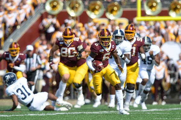 Gophers wide receiver Tyler Johnson broke away from Georgia Southern defenders for a touchdown in the first quarter.