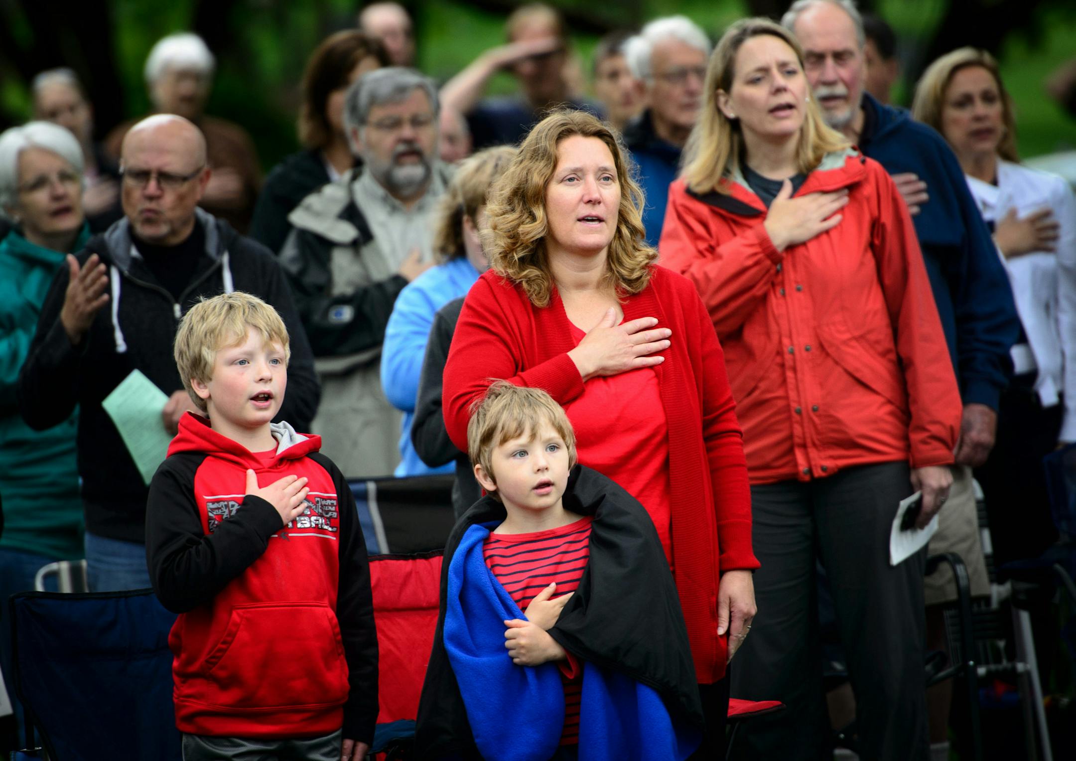 Stephanie LeGros of Stillwater, brought her sons James, 8 and Jack, 6 to the ceremony where they recited the Pledge of Allegiance. Her father a Korean war veteran is buried at Lakewood Cemetery. ] GLEN STUBBE * gstubbe@startribune.com , Monday, May 25, 2015 Traditional Memorial Day ceremony held near the Soldiers Memorial monument at Lakewood Cemetery, Minneapolis.