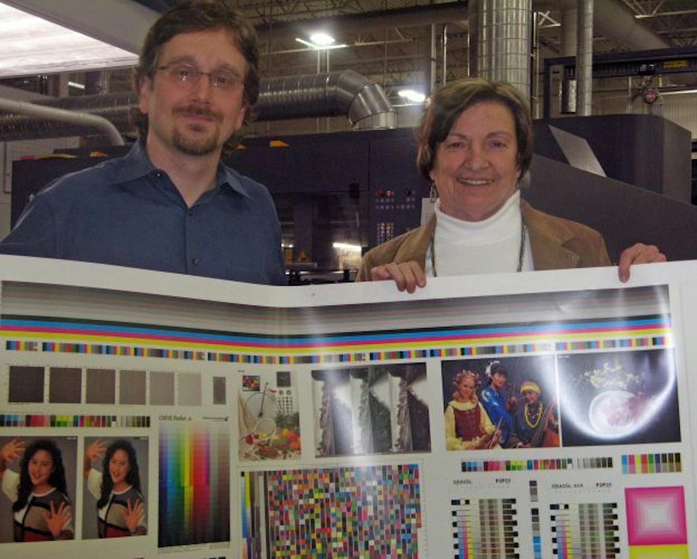 Bureau of Engraving Vice President Patrick Stuart and CEO Lynne Alexander in front of the company's new $6 million press.