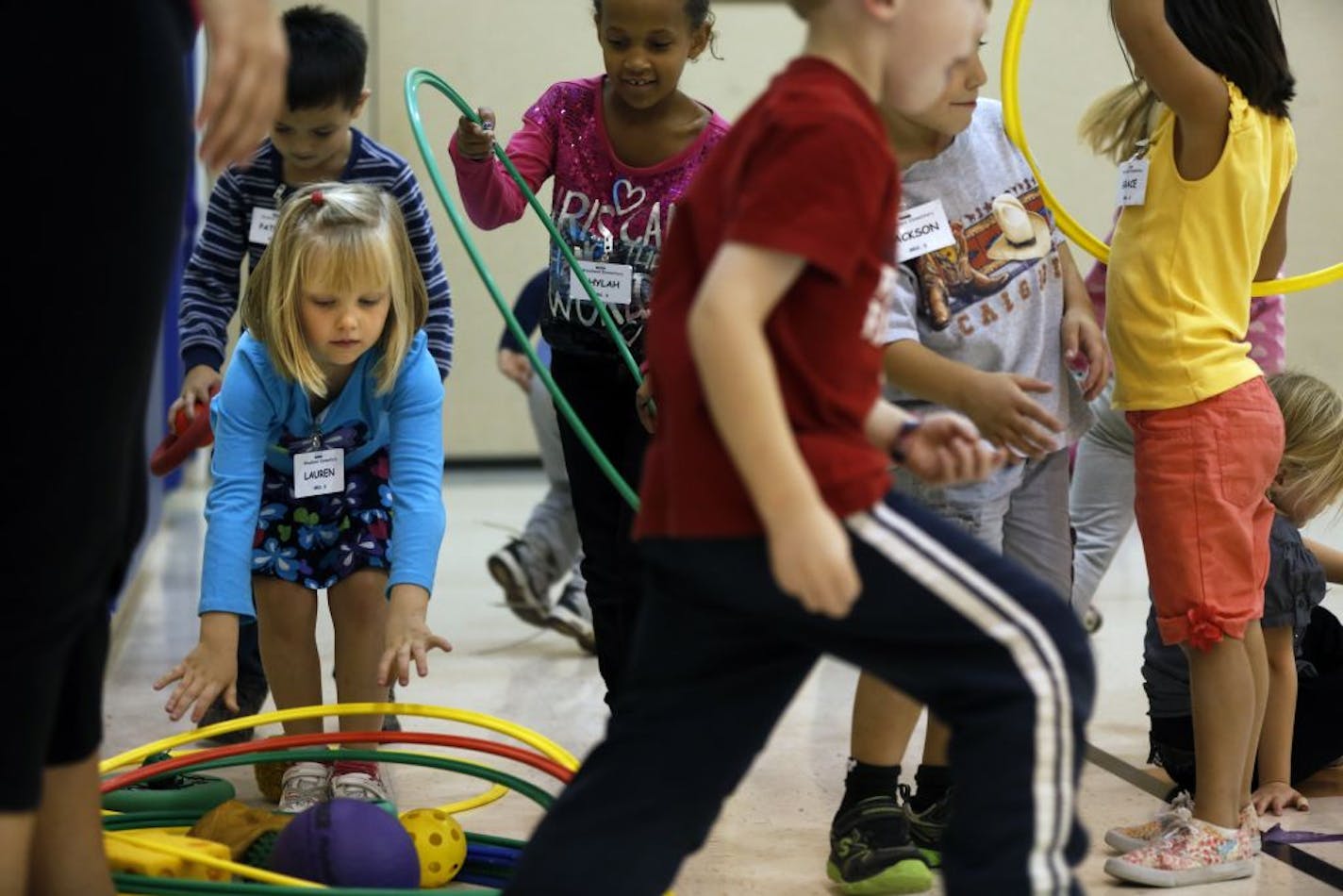 At Woodland Elementary in Brooklyn Park, all-day kindergartners helped put away some toys at the end of physical education class on Tuesday