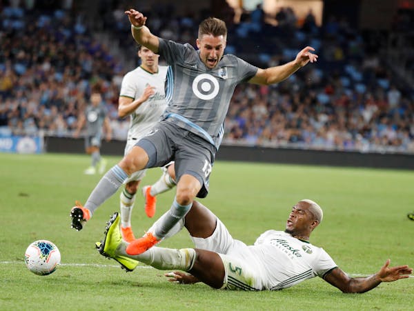 Minnesota United midfielder Ethan Finlay, left, accused MLS owners on Thursday of "bullying" the players into a labor agreement with threats of a lock