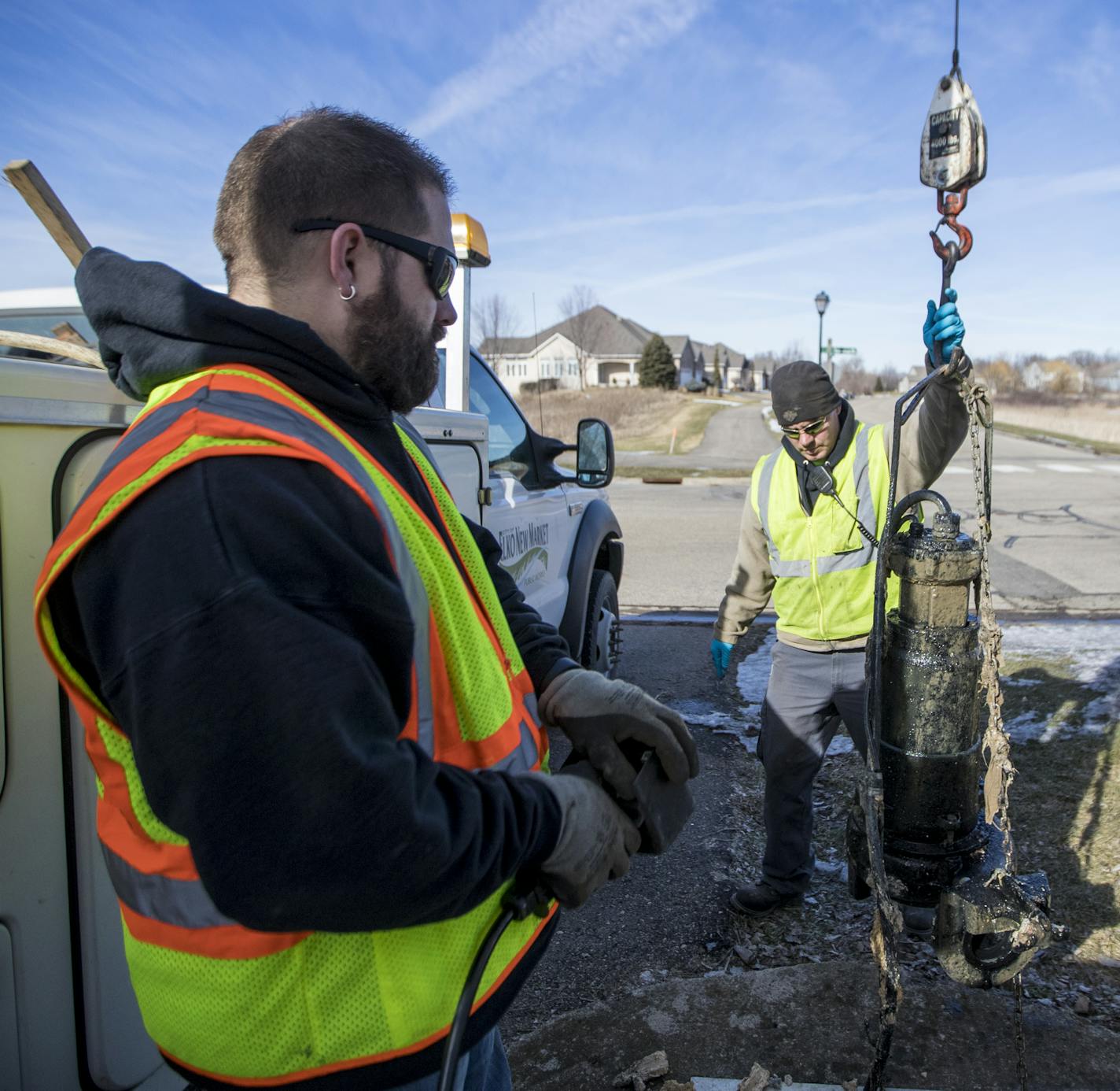 Public works superintendent Corey Schweich and maintenance worker Chad Shell checked on a lift station pump in a neighborhood in Elko, Minn. on Wednesday, February 15, 2017. The pumps get checked a few times a year to make sure they are not clogged with flushable wipes and rags. About 200 local homes dump into this station. ] RENEE JONES SCHNEIDER &#x2022; renee.jones@startribune.com