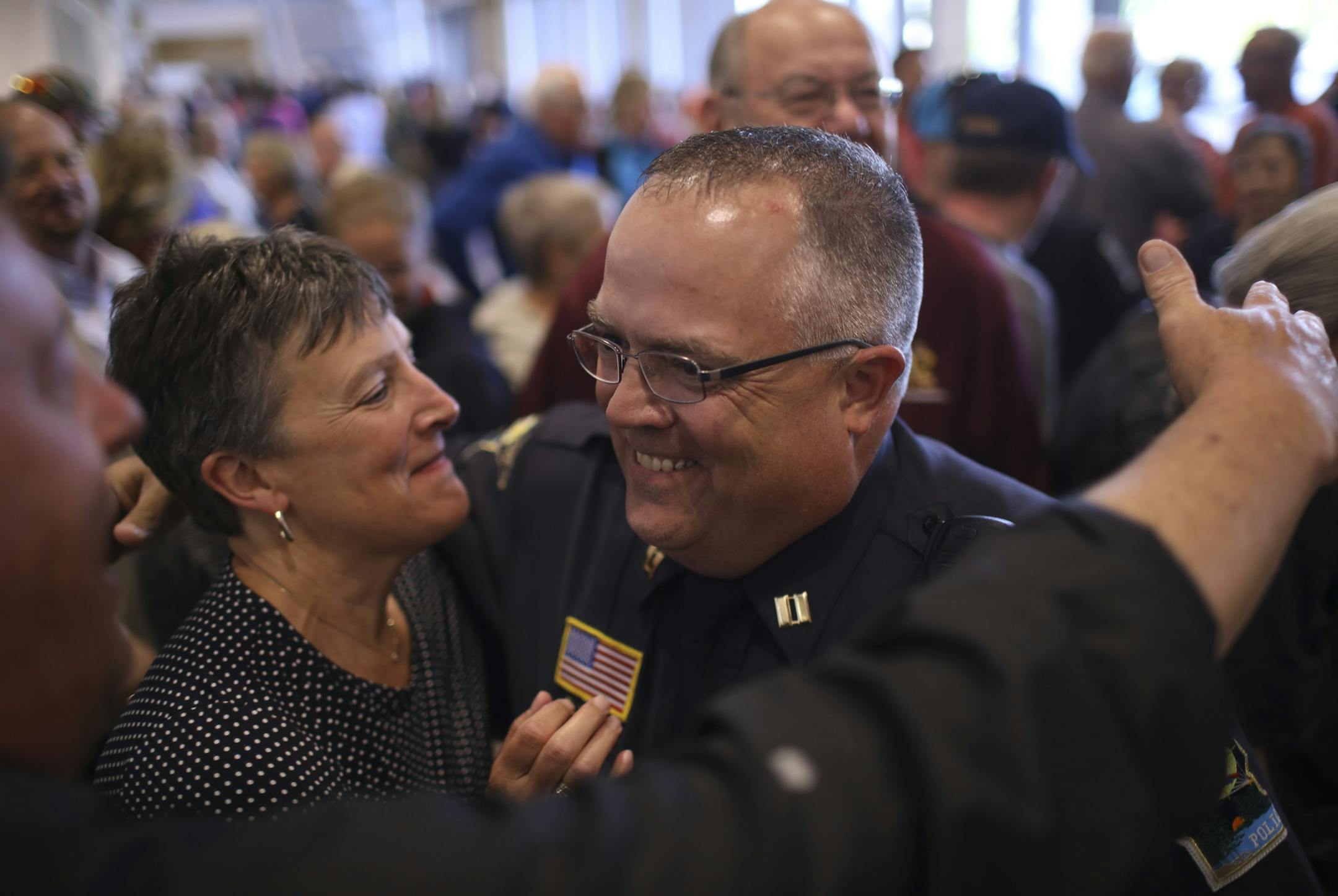 Forest Lake Police Capt. Greg Weiss was congratulated by Forest Lake Schools Superintendent Linda Madsen as he left the city council chambers after their vote to approve a contract with the police force. ] JEFF WHEELER &#xef; jeff.wheeler@startribune.com A packed council chambers saw the Forest Lake City Council voted to approve a labor contract with their police force Monday night, May 15, 2017, ending a drama that began last week when the same body effectively voted to disband the force.