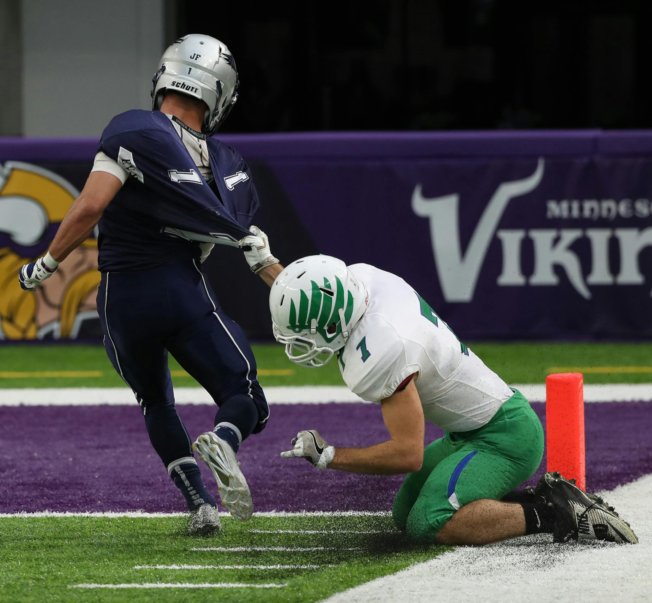 Matt Schindler of Eden Valley-Watkins is yanked down from behind by Maple River's Chandler See just before scoring a touchdown in the first half. ] Shari L. Gross / sgross@startribune.com Eden Valley-Watkins versus Maple River in a Minnesota State High School football semifinal game at U.S. Bank Stadium on Thursday, November 17, 2016 in Minneapolis, Minn.