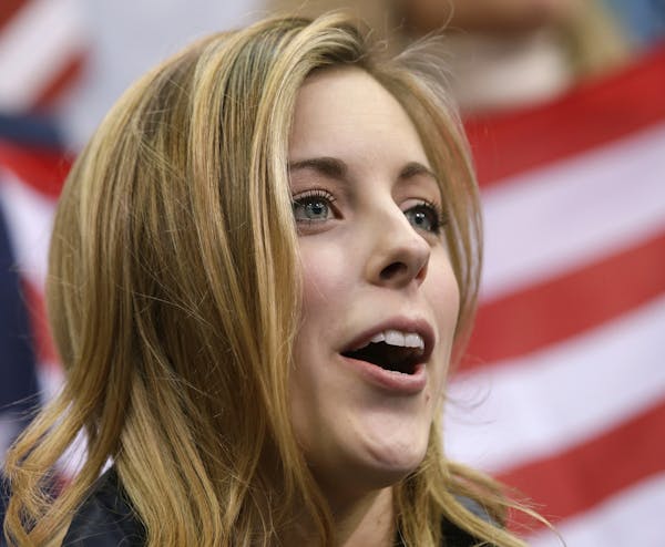 Ashley Wagner of the United States watches Jason Brown of the United States competes in the men's team free skate figure skating competition at the Ic