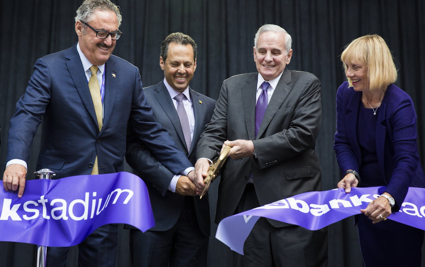 Minnesota Vikings co-owners Zygi and Mark Wilf, from left, Governor Mark Dayton and Michele Kelm-Helgen, the chair of the Minnesota-Sports Facilities Authority cut the ribbon at U.S. Bank Stadium. ] (Leila Navidi/Star Tribune) leila.navidi@startribune.com BACKGROUND INFORMATION: The ceremonial grand opening ribbon cutting for U.S. Bank Stadium in Minneapolis on Friday, July 22, 2016.