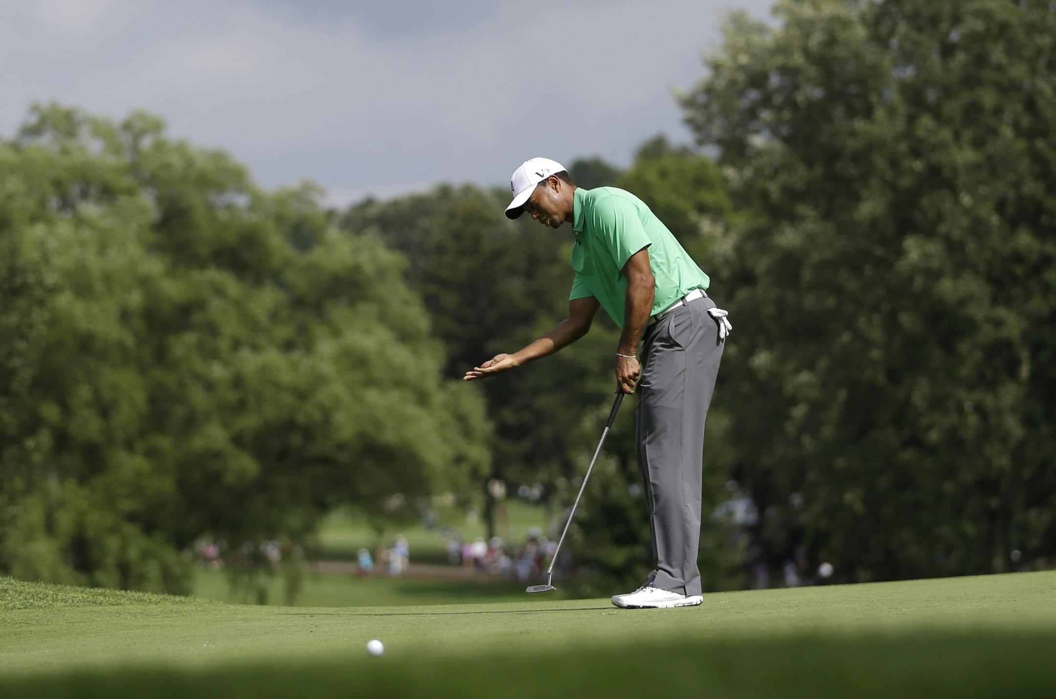 Tiger Woods reacts to a putt on the ninth hole during the second round of the PGA Championship golf tournament at Oak Hill Country Club, Friday, Aug. 9, 2013, in Pittsford, N.Y. (AP Photo/Julio Cortez)