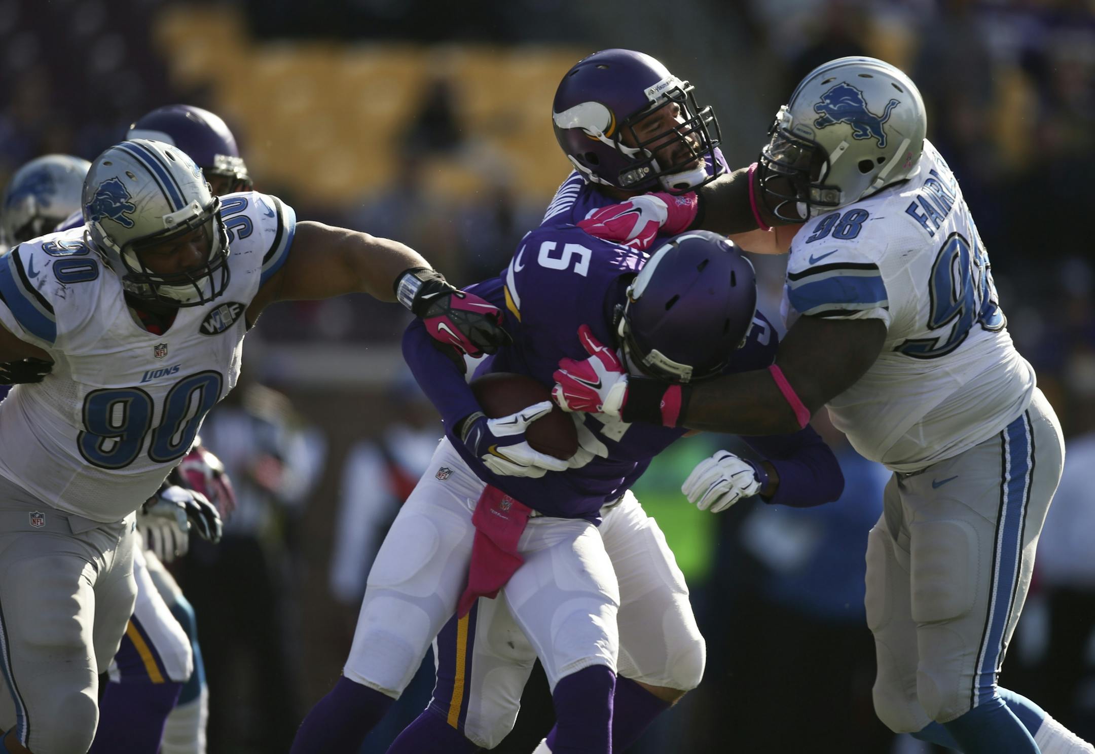 Minnesota Vikings quarterback Teddy Bridgewater (5) was sacked for a two yard loss by Detroit Lions defensive tackle Ndamukong Suh (90) late in the fourth quarter Sunday afternoon. Detroit Lions defensive tackle Nick Fairley (98) also had a hand in on the play.