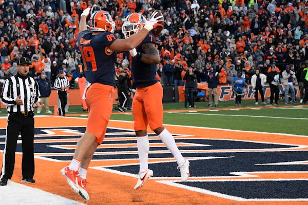 Illinois tight end Tip Reiman, left, and wide receiver Brian Hightower celebrated after a two-point conversion in last Saturday’s home loss to Michi