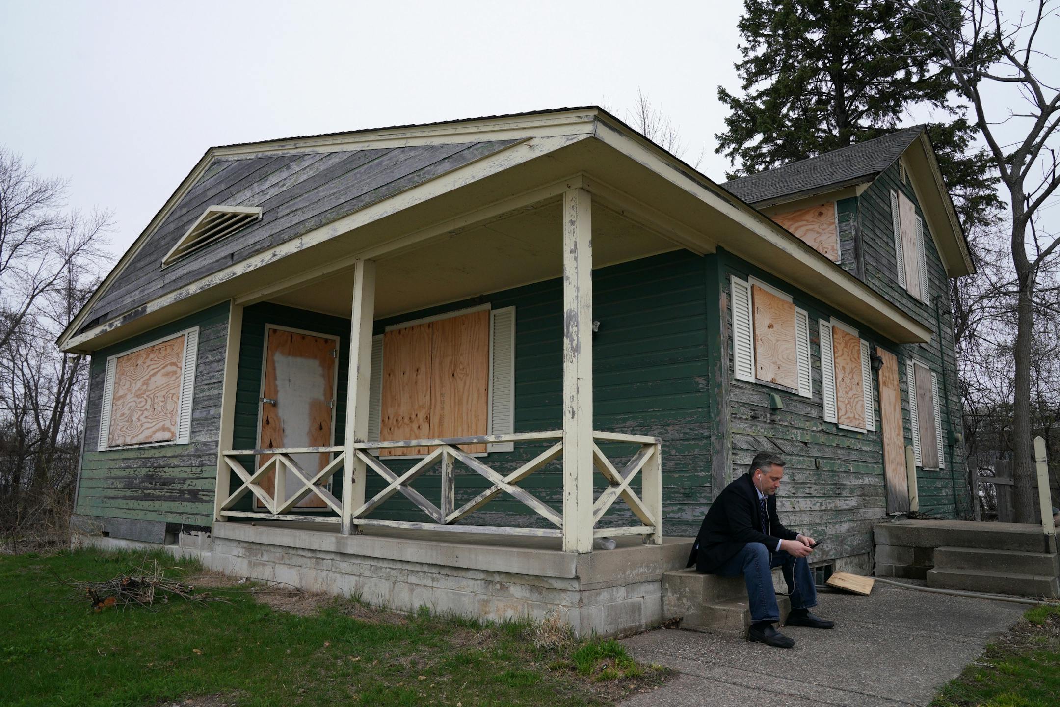 Dan Gustafson with the Heritage Preservation Board worked from his phone outside the 1902 Section Foreman House, a possible candidate for the National Register of Historic Places where the railroad foreman used to live, Thursday in Wayzata.