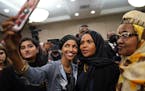 Ilhan Omar poses for a selfies with supporters after her victory Tuesday, Nov. 6, 2018, in Minneapolis. Omar is poised to become the first Somali-Amer