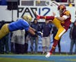 UCLA linebacker Eric Kendricks, left, blocks a punt by Southern California's Kris Albarado during the second half of their NCAA college football game,
