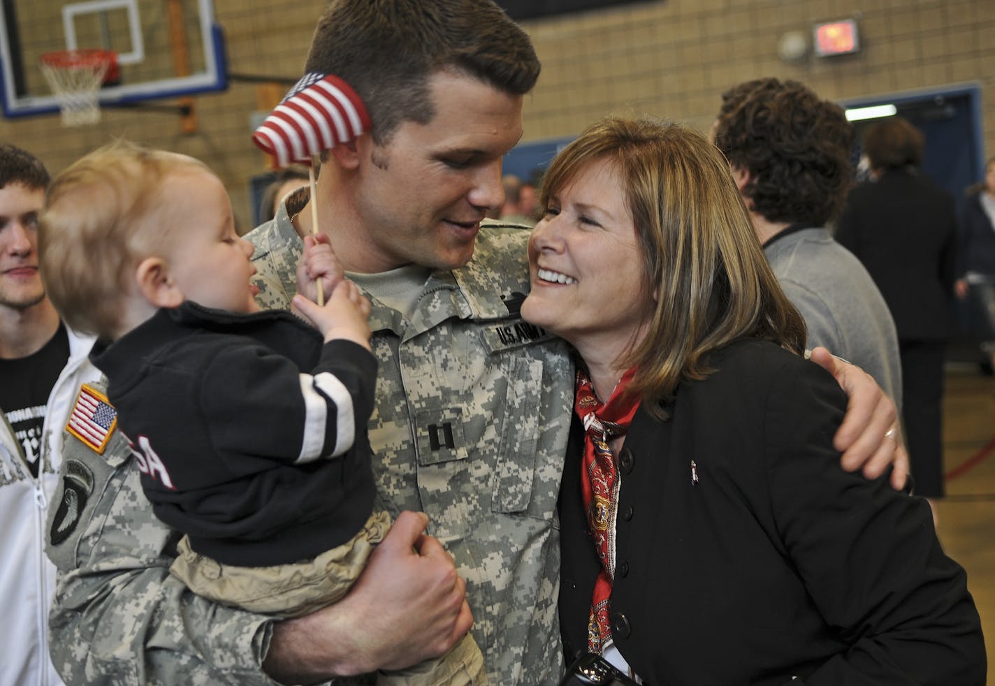 Today, a departure ceremony, for fifty five soldiers from the 2nd Combined Arms Battalion, 136 Infantry, Minnesota Army National Guard was held at the Rosemount Armory. The troops are leaving for a one year deployment in support of Operation Enduring Freedom.Capt. Pete Hegseth of Forest Lake, Mn. embraces his 10 month old son Gunner and his mom Penny Hegseth, after the deployment ceremony.