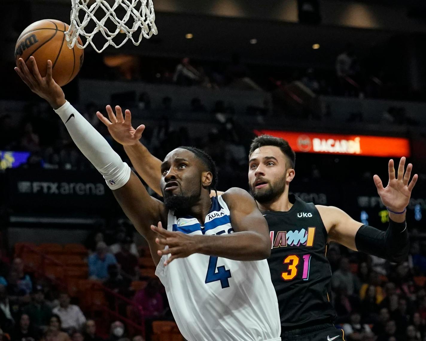 Timberwolves guard Jaylen Nowell (4) drove past Heat guard Max Strus during the first half Saturday in Miami.