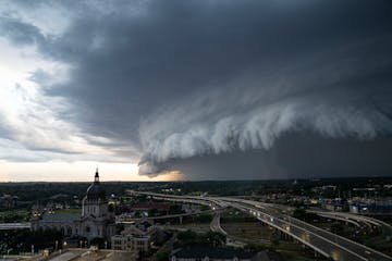 A warm summer evening brought storm clouds over the Basilica of St. Mary in Minneapolis and a rain delay for the Twins at nearby Target Field.