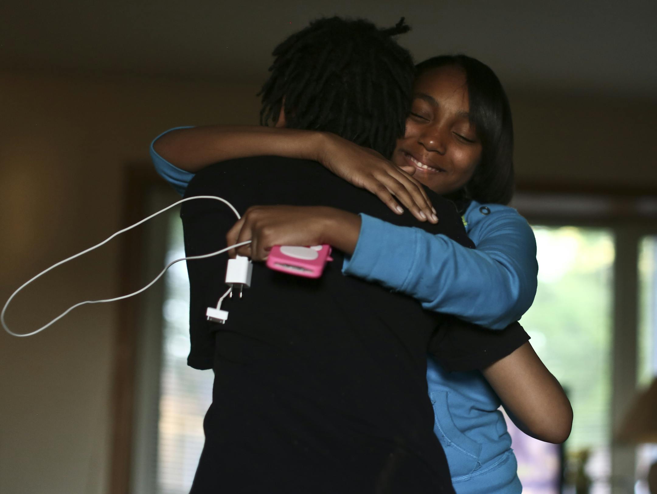 Gianni's cousin Sa'nya Storks hugged him after seeing him for the first time since he had returned home from spending 37 days at the Ramsey County Juvenile Detention Center on Thursday May 23, 2013 in Fridley, Minn. ] (RENEE JONES SCHNEIDER * reneejones@startribune.com) Sa'nya Storks CQ