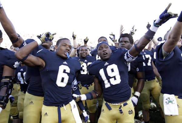 Notre Dame cornerback KeiVarae Russell (6) and wide receiver Davonte' Neal (19) celebrateafter beating Purdue in September 2012