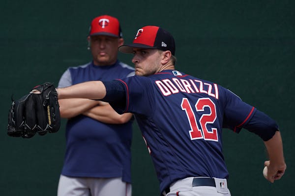 Minnesota Twins pitcher Jake Odorizzi (12) delivered a pitch as pitching coach Wes Jonson (47) watched Tuesday.] ANTHONY SOUFFLE &#x2022; anthony.souf