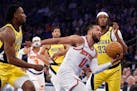 Jalen Brunson (11) of the Knicks drives past Aaron Nesmith (23) and Myles Turner (33) of the Pacers during the first quarter in Game 1.