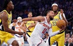 Jalen Brunson (11) of the Knicks drives past Aaron Nesmith (23) and Myles Turner (33) of the Pacers during the first quarter in Game 1.