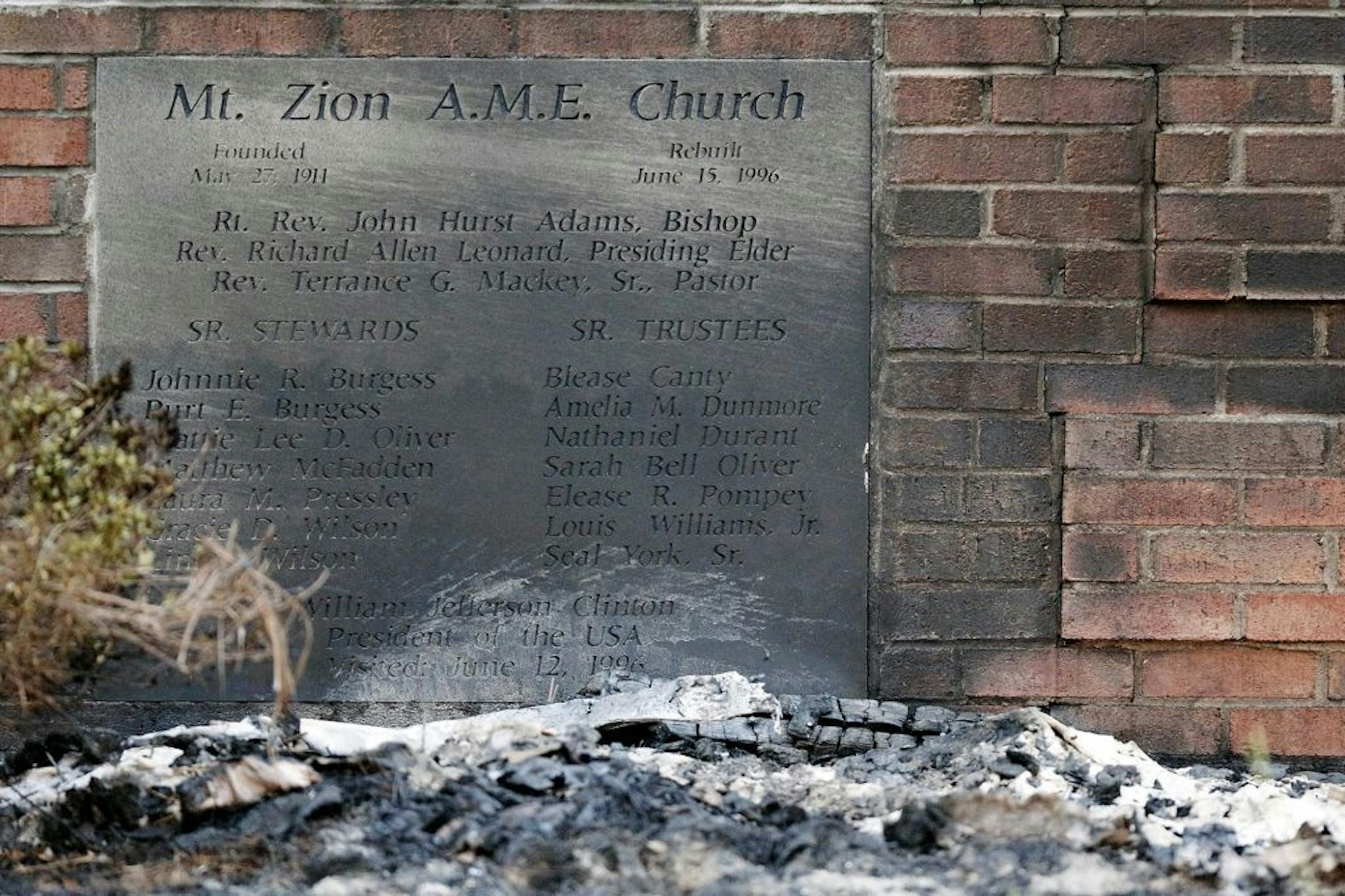 Ashes lie by a cornerstone outside Mount Zion African Methodist Episcopal Church, Wednesday, July 1, 2015, in Greeleyville, S.C. The African-American church, which was burned down by the Ku Klux Klan in 1995, caught fire Tuesday night, but authorities said arson is not the cause.