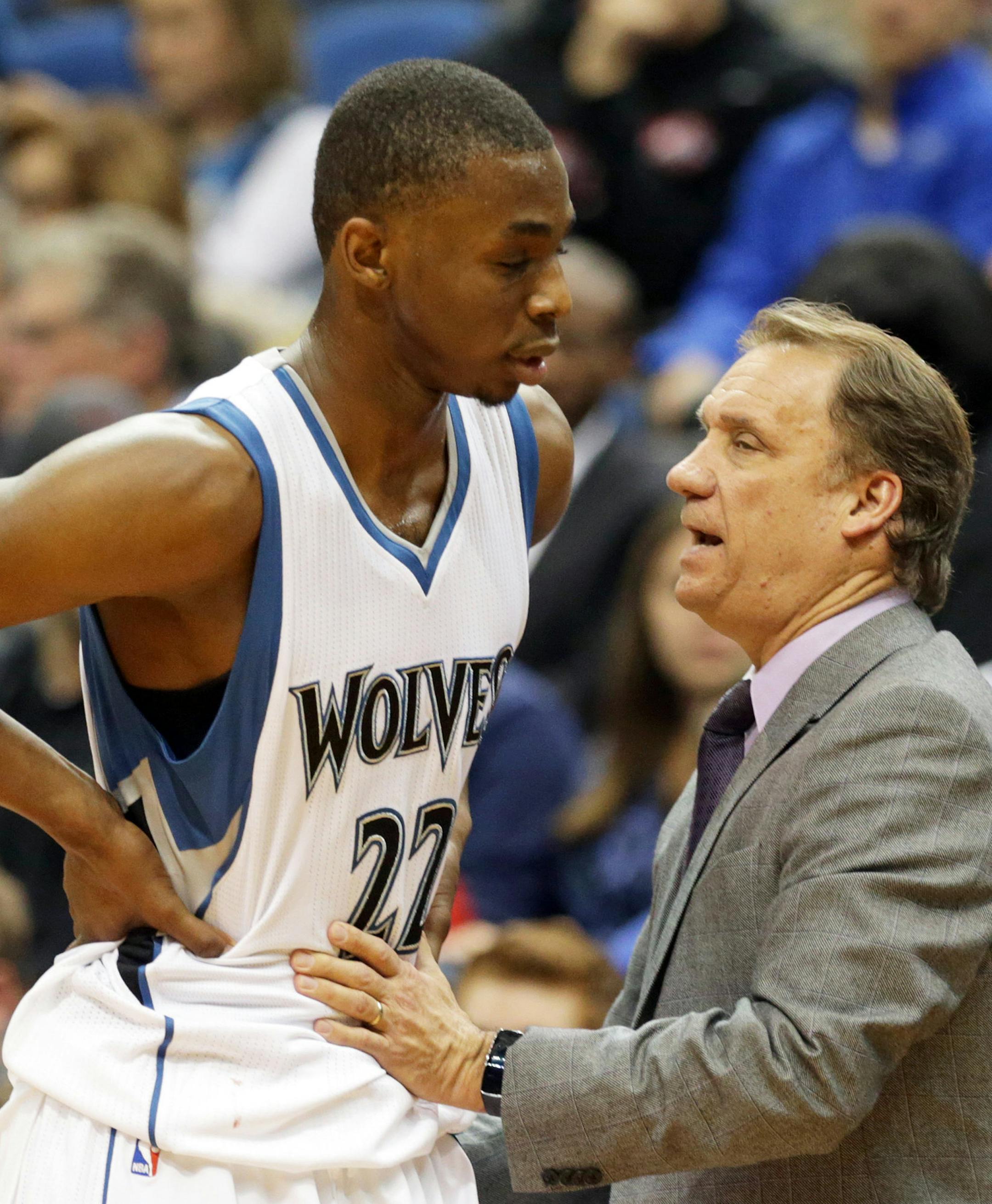 Minnesota Timberwolves head coach Flip Saunders, right, talks with rookie Andrew Wiggins who heads to the bench in the second half of an NBA basketball game against the San Antonio Spurs, Friday, Nov. 21, 2014, in Minneapolis. The Spurs won 121-92. (AP Photo/Jim Mone)