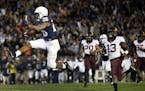 Penn State's Saquon Barkley (26) takes it in for the winning touchdown against Minnesota during overtime of an NCAA college football game in State Col