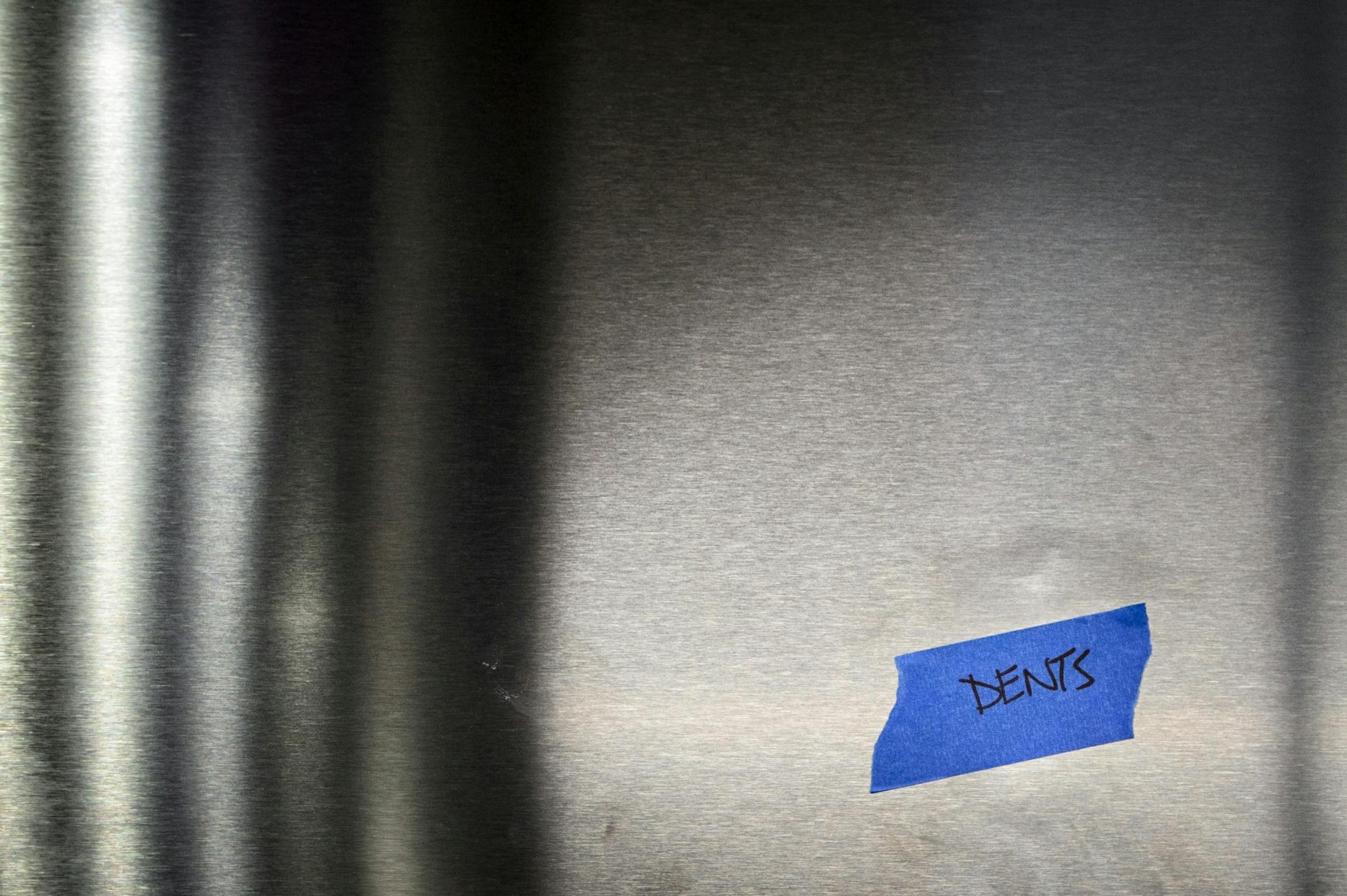 Dents in the stainless steel elevator.