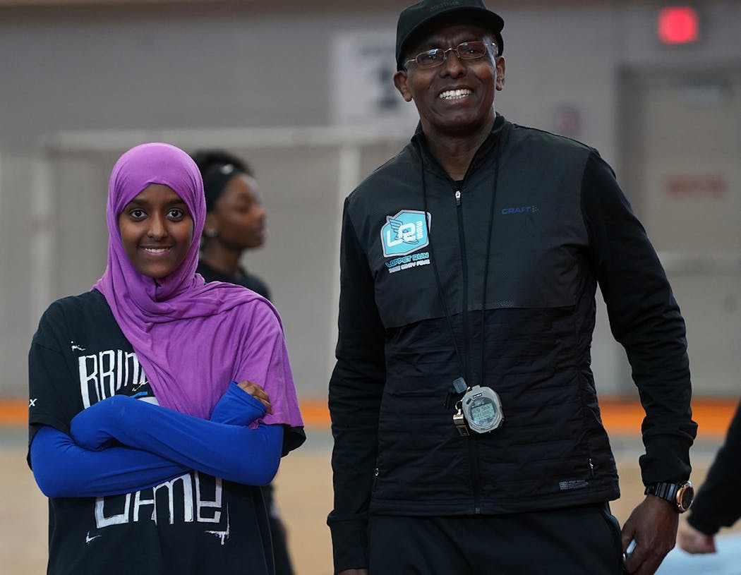 Abdi Bile, right, worked over the summer with Ayan Yusuf,18. Ayan had plans to run for Minneapolis South High School.
