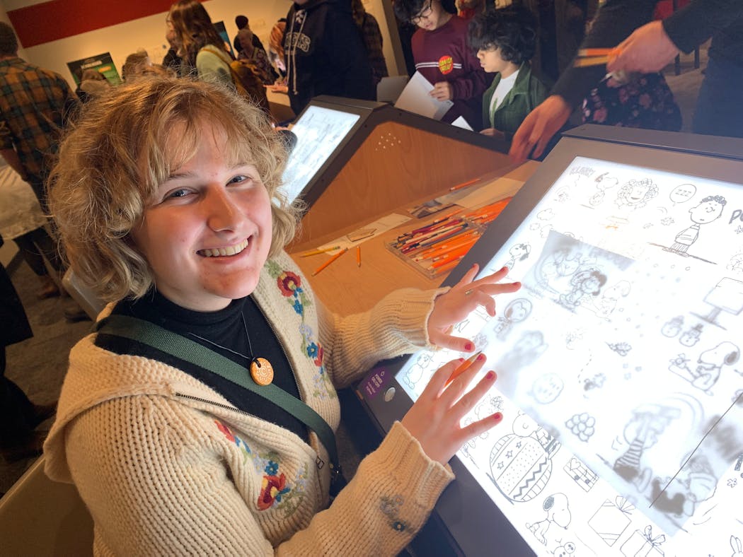 Addy Adams traced Snoopy at the Minnesota History Center’s exhibit on “Peanuts” creator Charles M. Schulz.