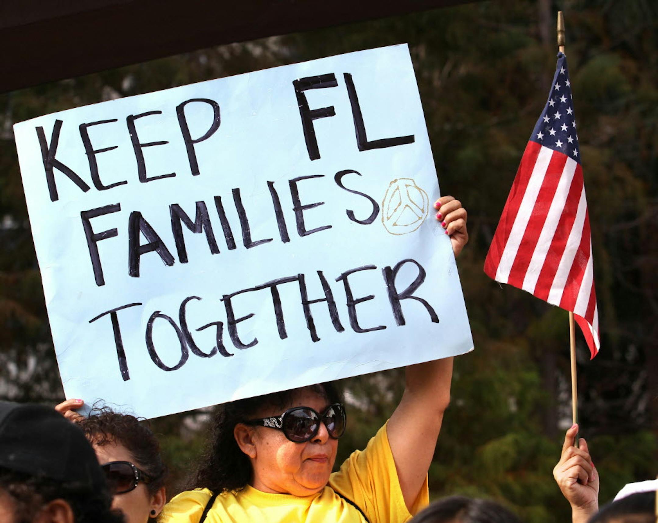 Hispanic immigration policy demonstrators from various groups march outside Sen. Marco Rubio's office in downtown Orlando, Fla.